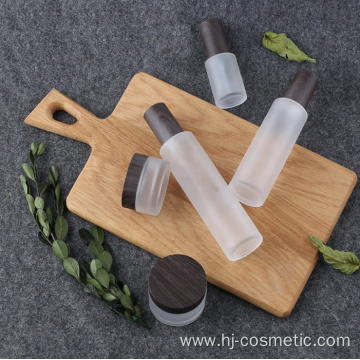 High-grade Cosmetic transparent Frosted glass bottles/jars with BLACK wood grain cap